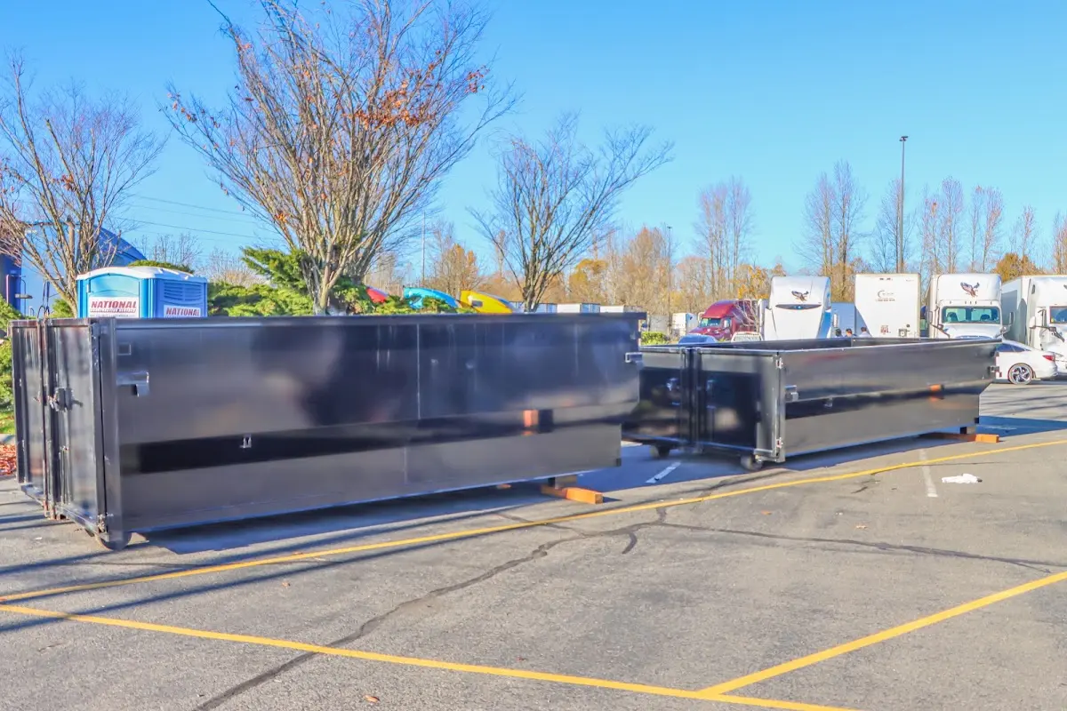 Professional dumpster rental service with roll-off container on residential driveway in Old Fig Garden